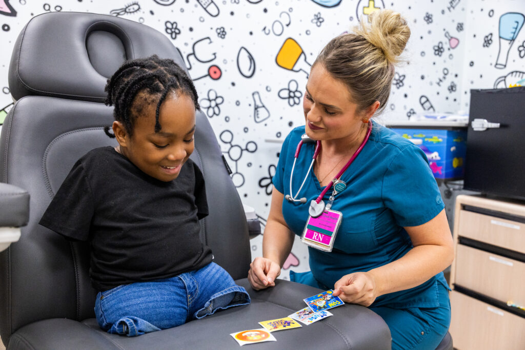 Champion Rondell with a Child Life Specialist.